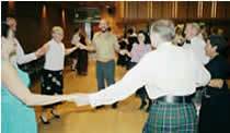 Eight Scottish dancers in a set enjoying dancing eight hands round at the end of one of our informal dances (Carol Knights)