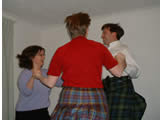 Three Scottish country dancers from Brighton Branch dancing a circle, called three hands round (Helen Sandwell)
