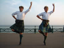 RSCDS dancers dancing the highland fling on Brighton seafront, by Helen Sandwell