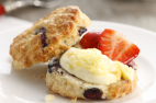 a scone with cream and a strawberry; available during the dance interval